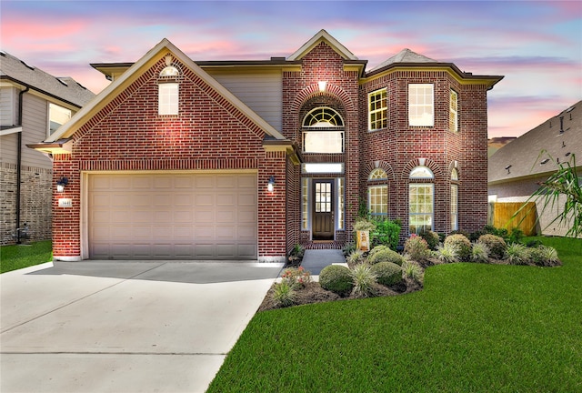 view of property with a garage and a yard