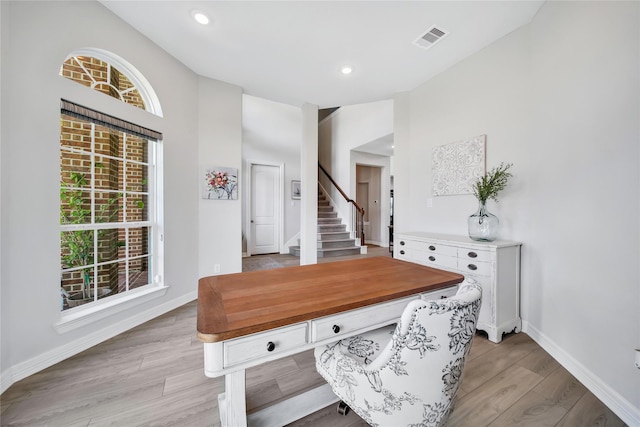 office area featuring light hardwood / wood-style floors and lofted ceiling