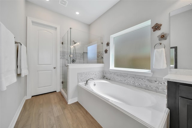 bathroom with vanity and separate shower and tub