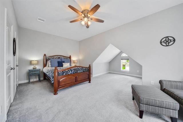 carpeted bedroom with ceiling fan and vaulted ceiling