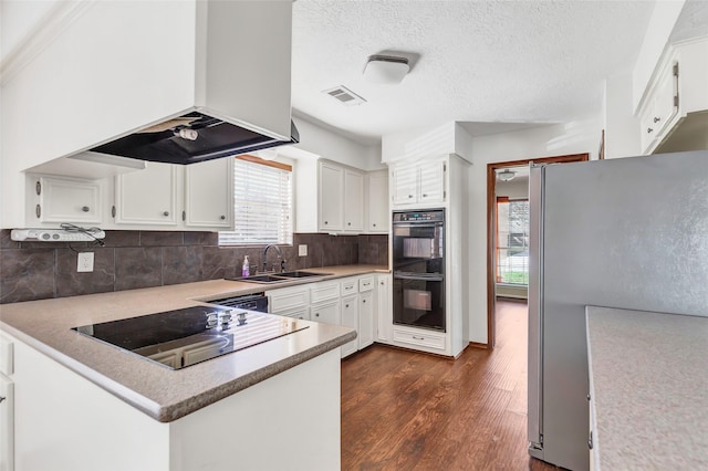 kitchen with white cabinetry, sink, dark wood-type flooring, black appliances, and custom exhaust hood