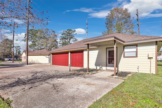 view of front of home with a front yard and a garage