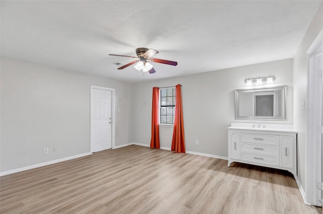 unfurnished bedroom featuring ceiling fan and light hardwood / wood-style floors