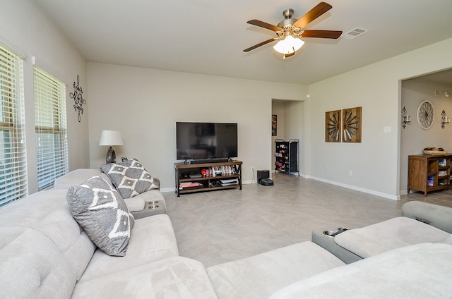 living room featuring ceiling fan and light tile patterned flooring