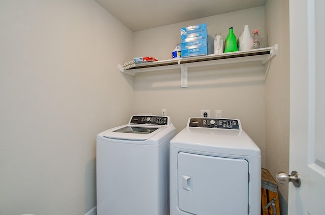 clothes washing area featuring washer and dryer