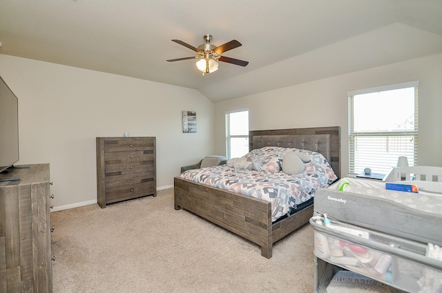 carpeted bedroom with vaulted ceiling and ceiling fan