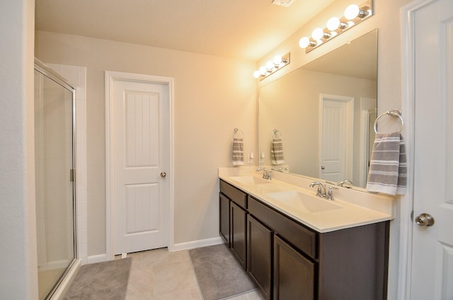 bathroom featuring tile patterned flooring, vanity, and walk in shower