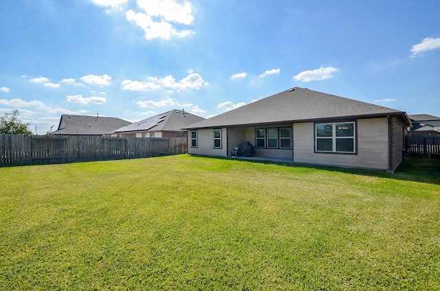 back of property featuring a yard