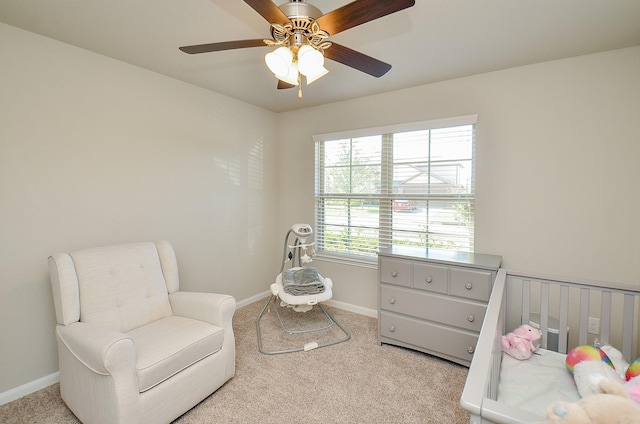 living area featuring light carpet and ceiling fan