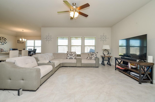 living room featuring ceiling fan with notable chandelier