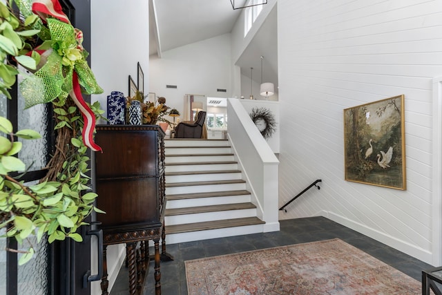 stairway featuring a high ceiling