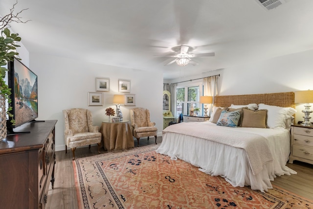 bedroom with ceiling fan and dark hardwood / wood-style floors