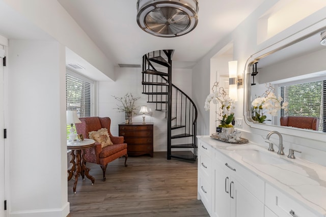 interior space with light stone countertops, white cabinets, plenty of natural light, and dark hardwood / wood-style floors