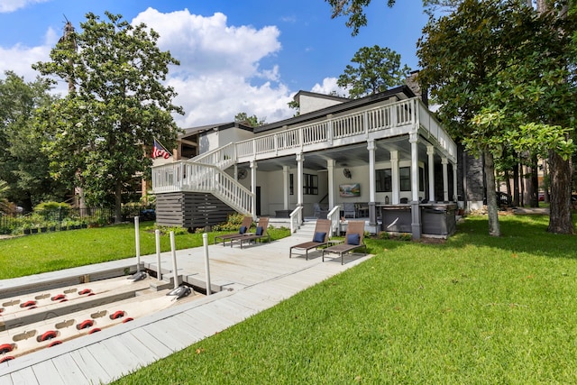 back of property with a patio area, a yard, and a wooden deck