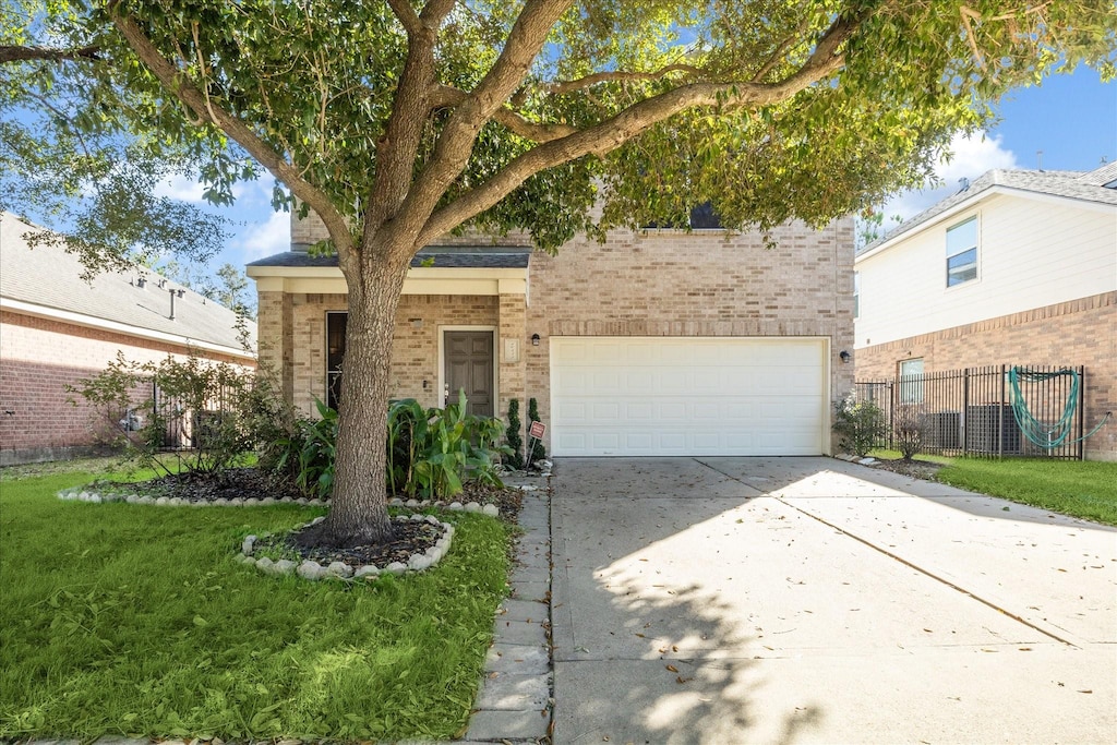 view of front of home featuring a front yard and a garage