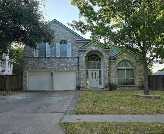 view of front of home featuring a garage and a front yard