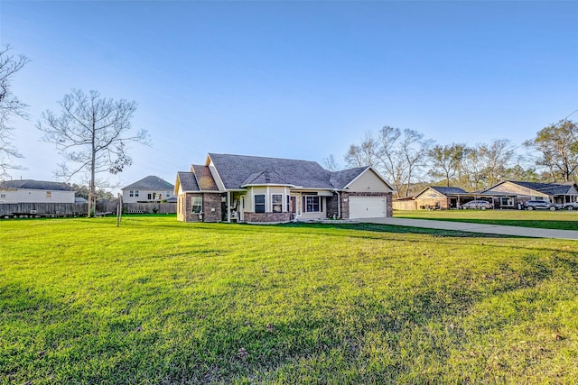 view of front of home with a front yard and a garage