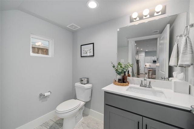 bathroom featuring vanity and toilet