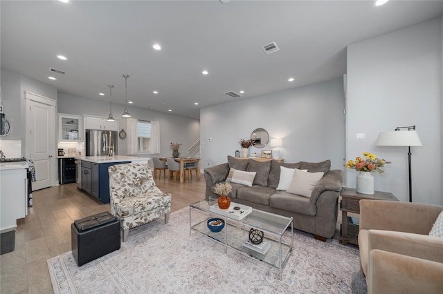 living room featuring light wood-type flooring and wine cooler