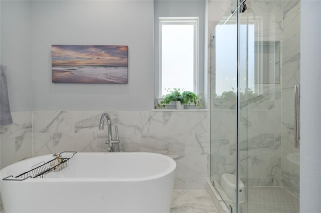 bathroom featuring tile walls and shower with separate bathtub