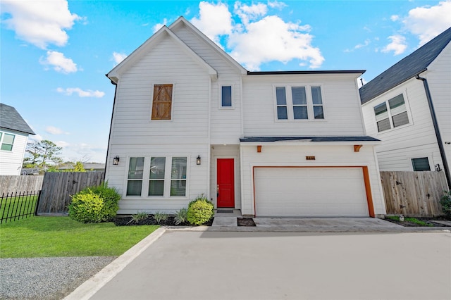 view of front of home featuring a garage and a front yard