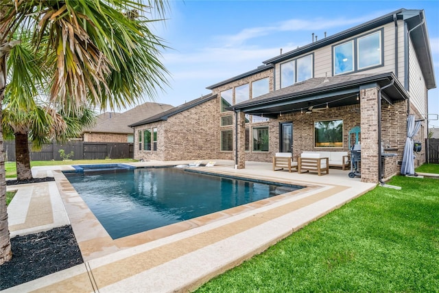 back of property featuring an outdoor hangout area, ceiling fan, a patio area, a yard, and a fenced in pool