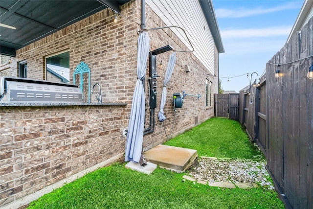 view of side of home with a yard