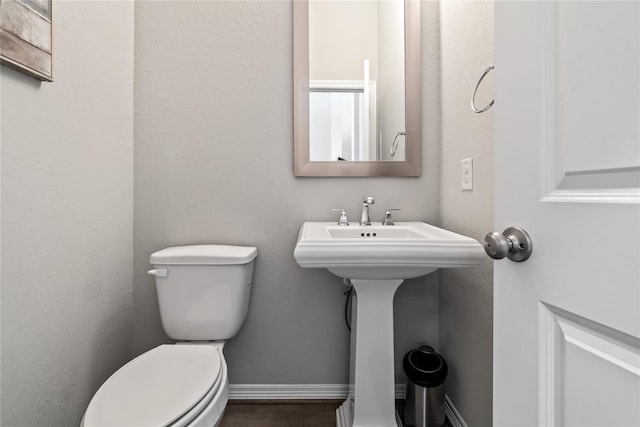 bathroom featuring toilet and sink