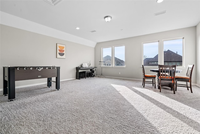 playroom featuring carpet floors and vaulted ceiling