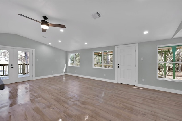 unfurnished living room with french doors, a wealth of natural light, ceiling fan, and lofted ceiling