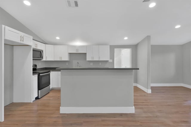 kitchen featuring appliances with stainless steel finishes, a center island, light hardwood / wood-style floors, and white cabinetry