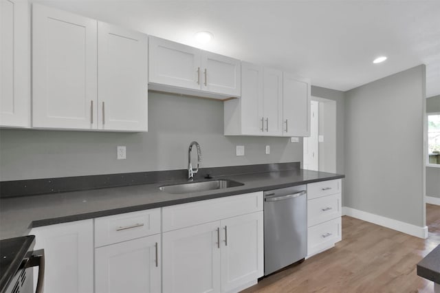 kitchen with stainless steel dishwasher, light hardwood / wood-style floors, white cabinets, and sink