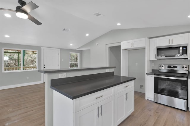 kitchen featuring white cabinetry, ceiling fan, light hardwood / wood-style flooring, vaulted ceiling, and appliances with stainless steel finishes