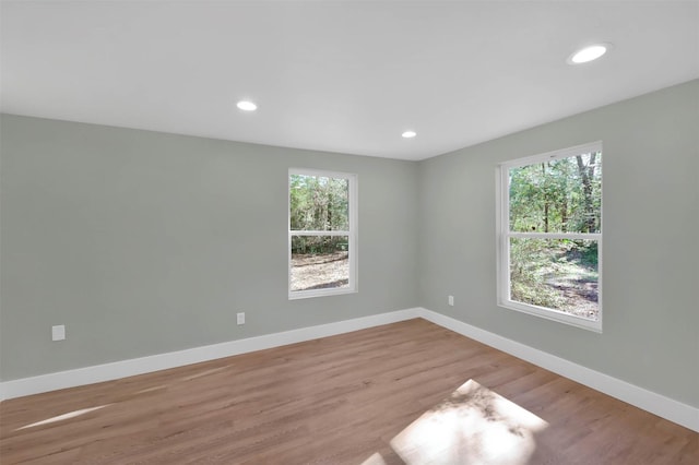 unfurnished room with light hardwood / wood-style flooring