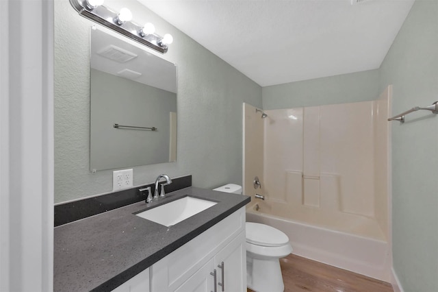 full bathroom with hardwood / wood-style flooring, vanity, toilet, and bathing tub / shower combination