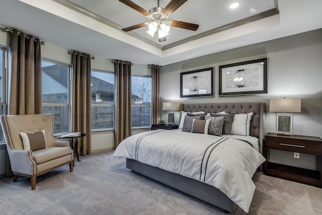 bedroom with light colored carpet, a raised ceiling, ceiling fan, and crown molding