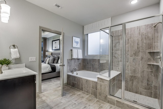 bathroom featuring vanity and independent shower and bath