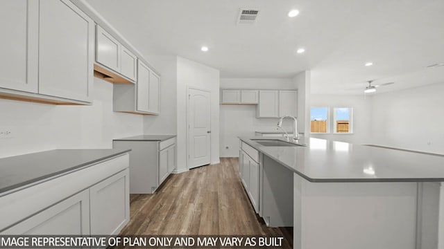 14611 Lost Cave Way, New Caney, TX 77357 - kitchen with wood finished floors, a kitchen island with sink, recessed lighting, and ceiling fan
