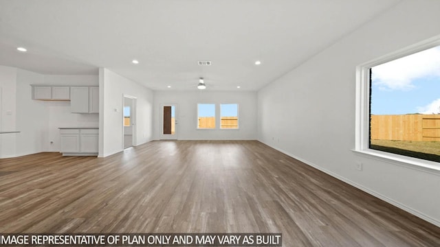 14611 Lost Cave Way, New Caney, TX 77357 - unfurnished living room featuring ceiling fan, wood finished floors, and recessed lighting