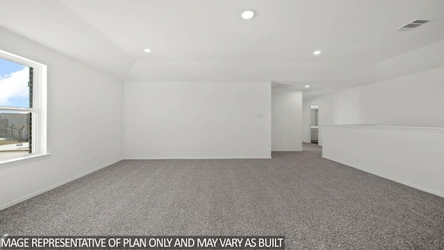 carpeted spare room with vaulted ceiling