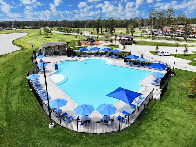 view of pool featuring a patio area and a yard