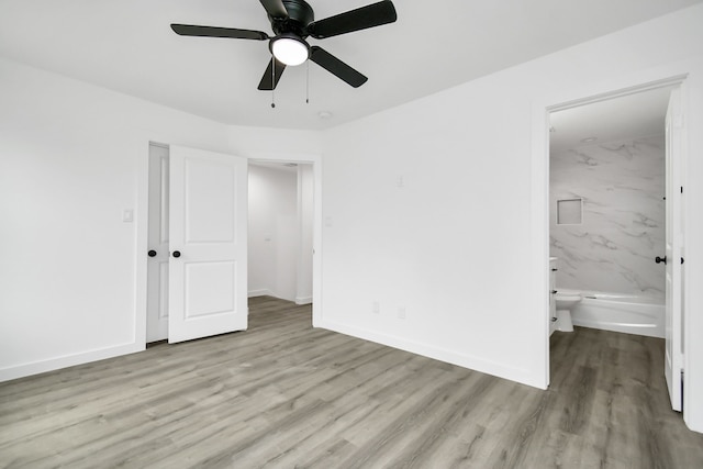 unfurnished bedroom with ensuite bathroom, ceiling fan, light hardwood / wood-style floors, and a closet