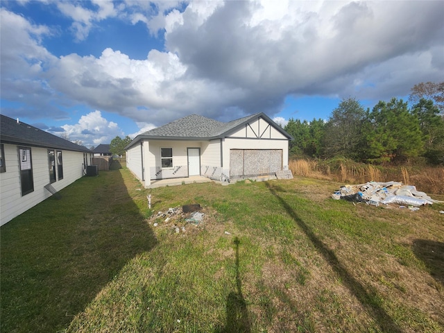 back of property featuring a lawn