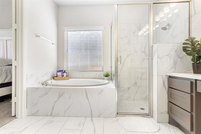 bathroom with vanity and separate shower and tub