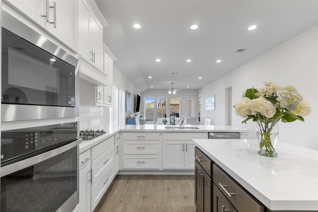 kitchen featuring ceiling fan, white cabinetry, sink, and appliances with stainless steel finishes