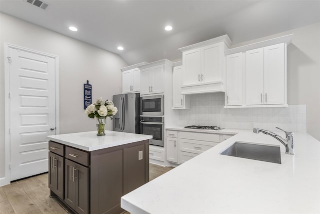 kitchen with sink, white cabinets, and stainless steel appliances