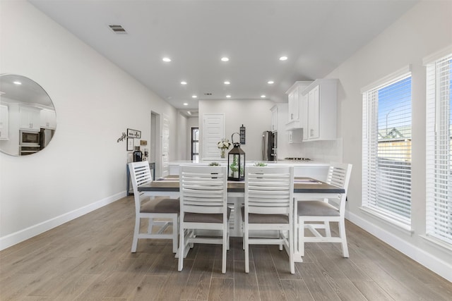 dining area featuring light wood-type flooring