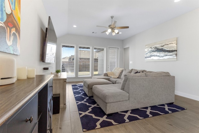 living room featuring dark hardwood / wood-style flooring, ceiling fan, and lofted ceiling