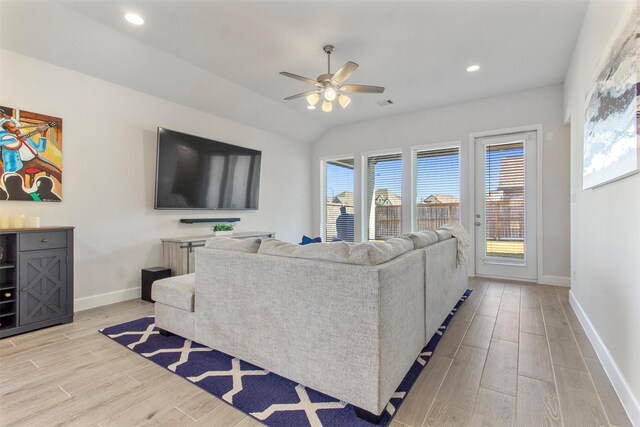 living room with ceiling fan and vaulted ceiling