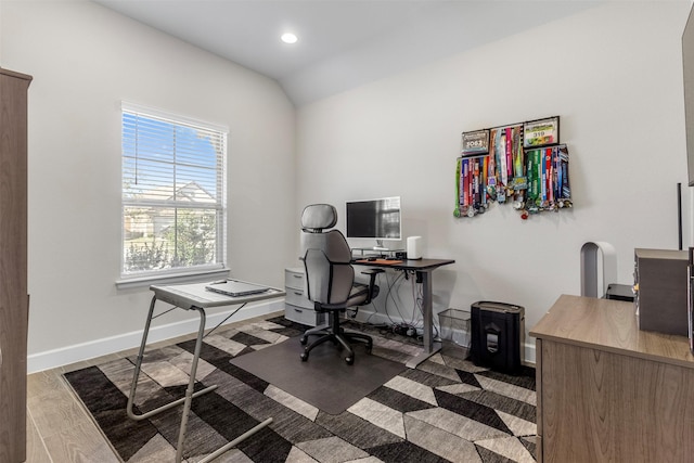 office with wood-type flooring and vaulted ceiling